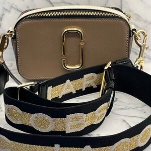 Marc Jacob’s tan, black, and cream leather crossbody